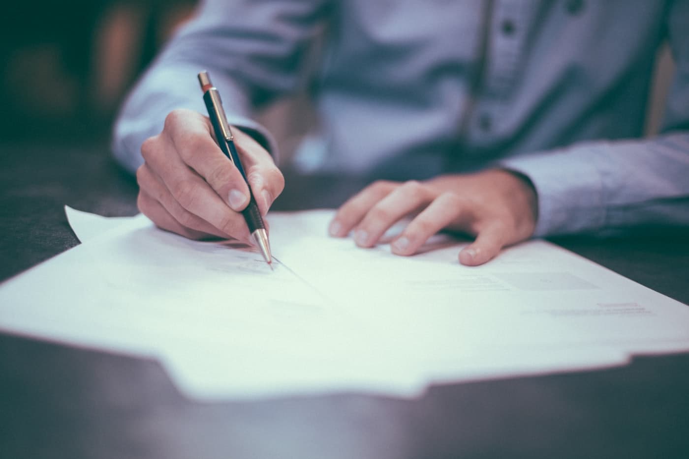 Hand signing a document