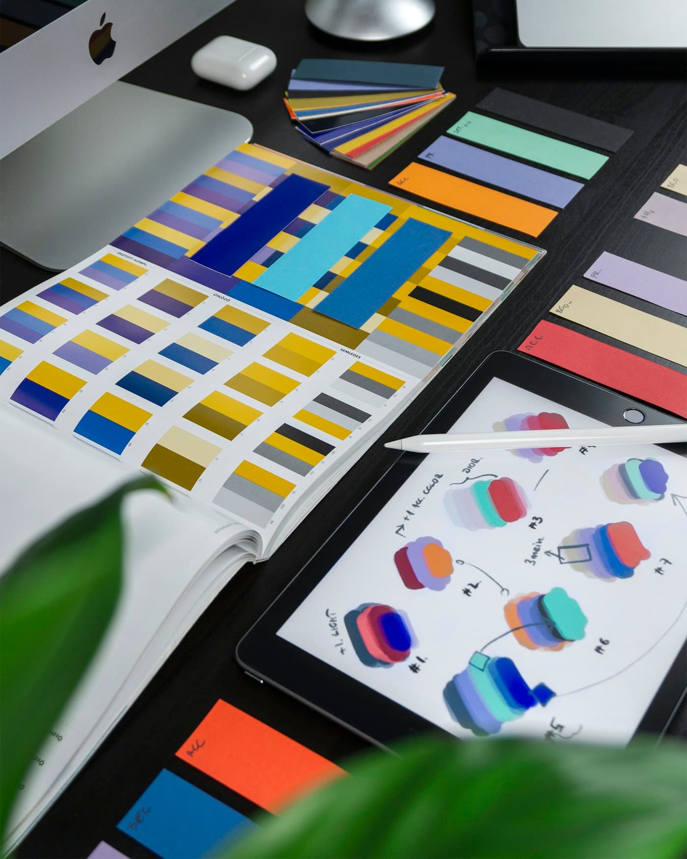 Color swatches and a tablet with design sketches